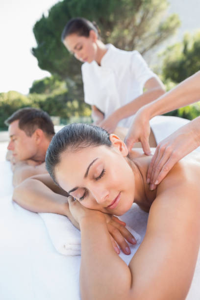 istock Attractive couple enjoying couples massage poolside 691350084