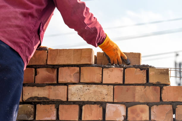 istock Worker builds a brick wall in the house 691350690