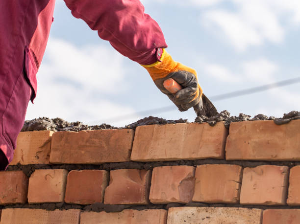 istock Worker builds a brick wall in the house 691352772