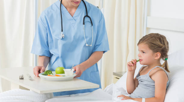 istock Doctor feeding breakfast to sick girl 691356616