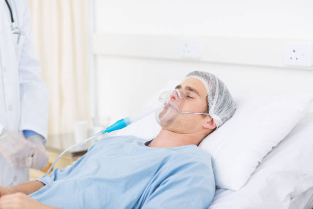 istock Male doctor adjusting oxygen mask on patient 691357236