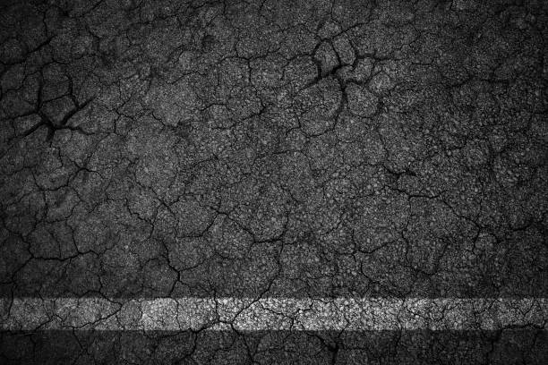 istock Old crack asphalt road with white lines 691359924