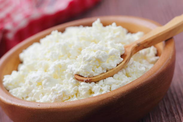 Cottage cheese in a bowl Cottage cheese in a wooden bowl cottage cheese photos stock pictures, royalty-free photos & images