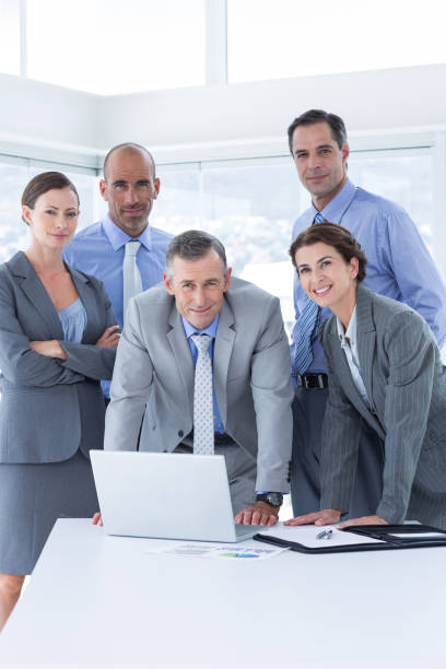 istock Business team working happily together on laptop 691366770