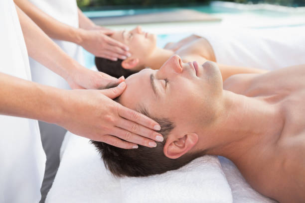istock Content couple enjoying head massages poolside 691367234