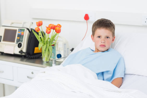 istock Boy reclining in hospital bed 691370448
