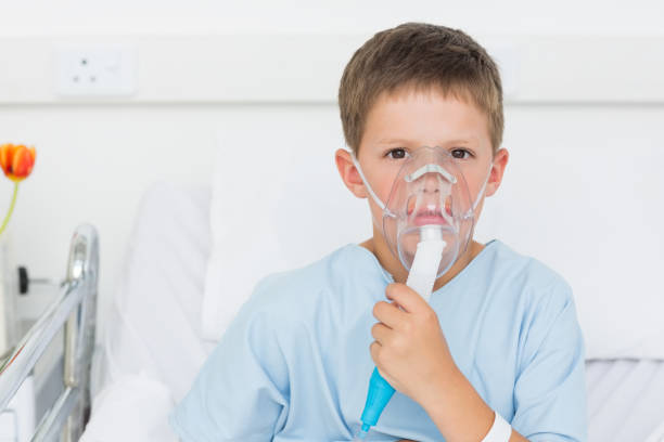 istock Boy wearing oxygen mask in hospital bed 691370712