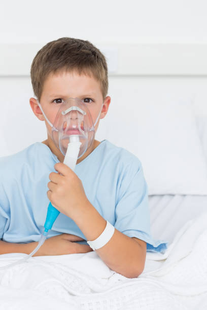 istock Boy wearing oxygen mask in hospital ward 691370718