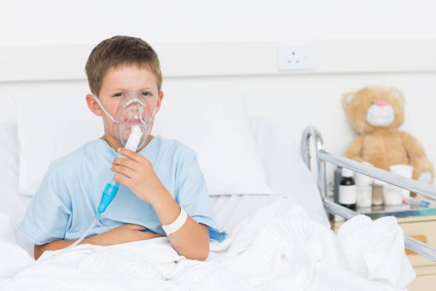 istock Boy wearing oxygen mask in hospital 691370722