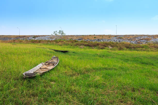 istock Old wooden boat trees in a sunny field in spring 691370852
