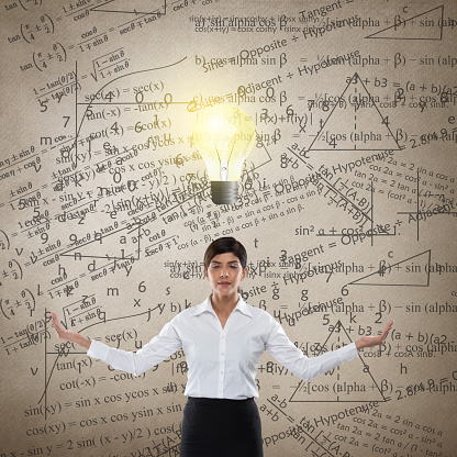 Businesswoman with glowing light bulb and mathematical equation
