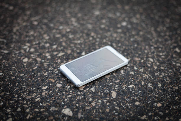 Phone with broken screen lying on the street