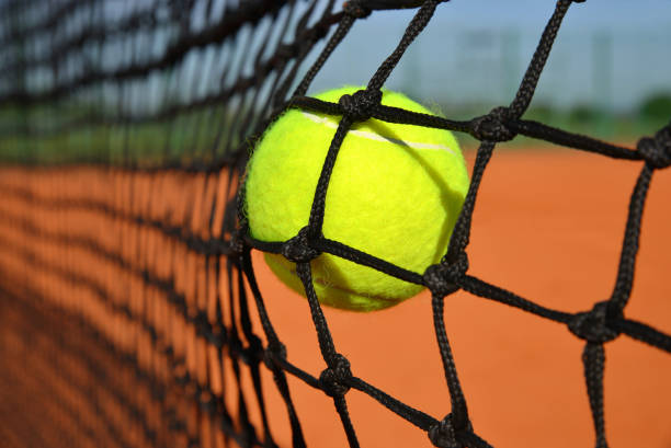 Shade Of Tennis Racket Over Ball On Court