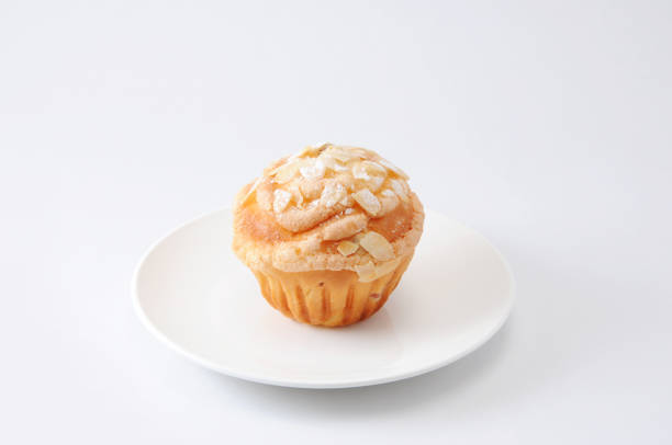cup cake muffin with almond and suggar on a plate on white background