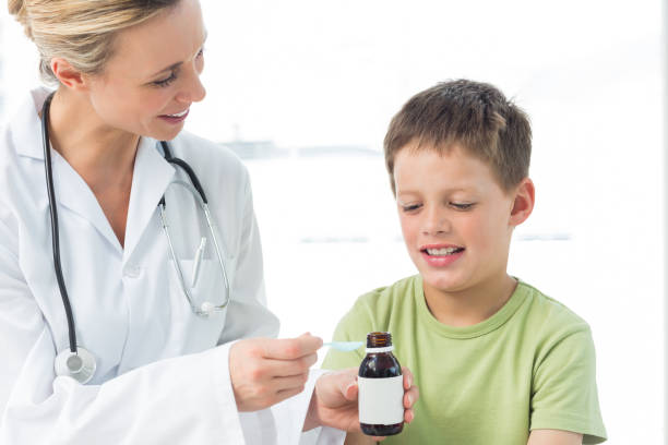 istock Pediatrician giving little boy syrup 691388288