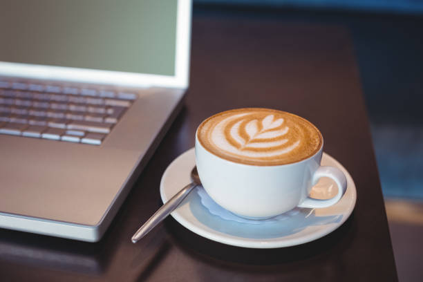 istock Close-up of laptop and coffee on table 691392778
