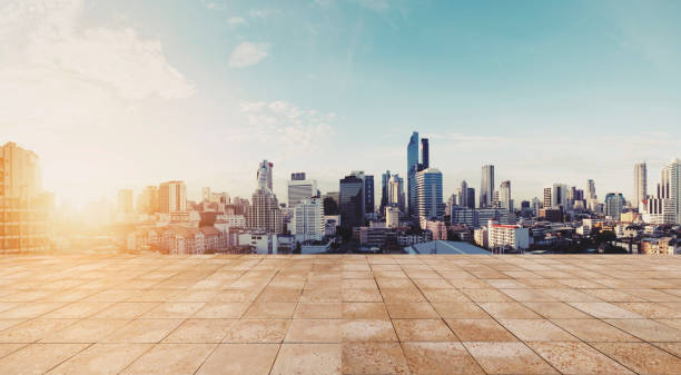istock Panoramic city view in sunrise with empty wooden floor 691394812