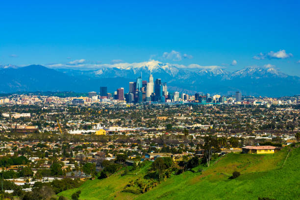 istock Los Angeles Skyline with Snow-capped Mountains from a Hill 691406310