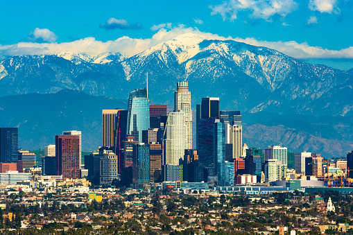 Downtown Los Angeles with the new Wilshire Grand skyscraper, Los Angeles’ tallest building by pinnacle, and with the snow-capped San Gabriel Mountains in the background.