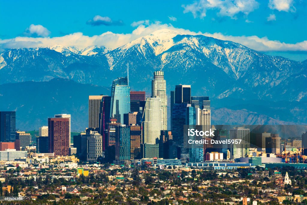 Los Angeles Skyline With A New Skyscraper And With Snow-capped Mountains Downtown Los Angeles with the new Wilshire Grand skyscraper, Los Angeles’ tallest building by pinnacle, and with the snow-capped San Gabriel Mountains in the background. City Of Los Angeles Stock Photo