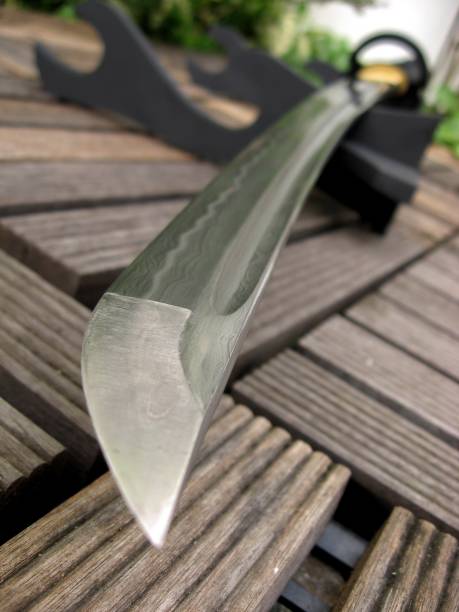 istock Japanese sword  in garden background  selective focus 691407212