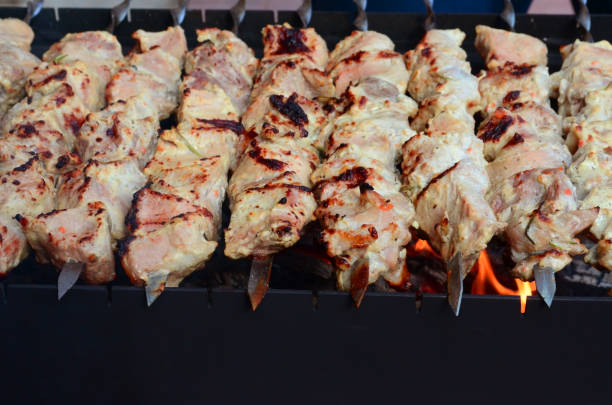 juicy shish kebab on skewers juicy shish kebab on skewers on the grill smoking meat rotisserie barbecue grill stock pictures, royalty-free photos & images