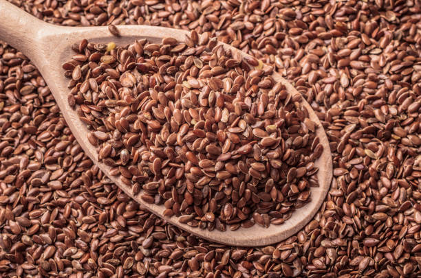 istock Flax seeds linseed on wooden spoon 691414672