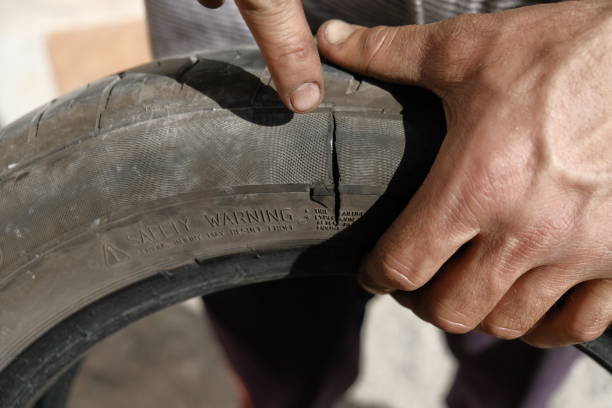 istock Explosive car tire and rubber tire repairer hands 691414798