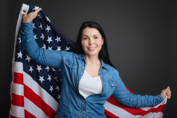 istock Proud loyal lady holding up Stars and Stripes 691417642