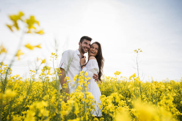 istock Happy embraced couple enjoying in spring day in a meadow. 691417734