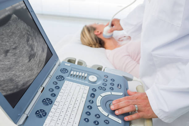 istock Doctor using sonogram on neck of female patient 691417842