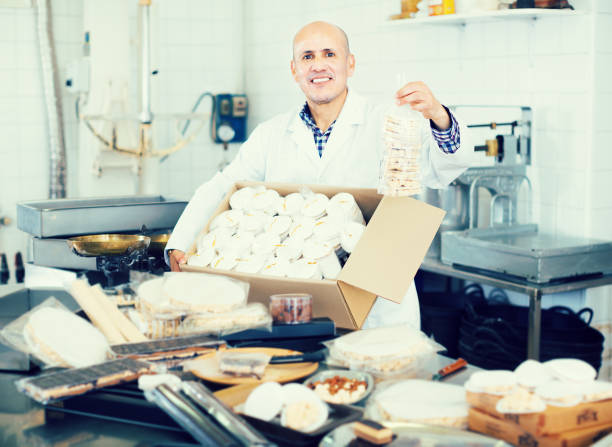istock Smiling mature man standing with box of turron 691418222