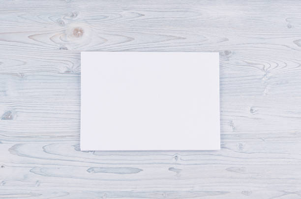 istock Blank white paper A4, envelope on soft light blue wooden board. Mock up for branding identity. 691418486