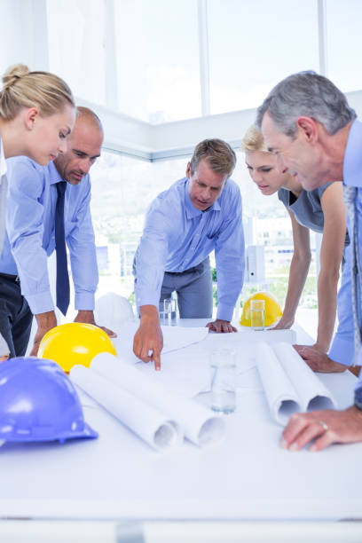 istock Team of business people looking at construction plan 691419050