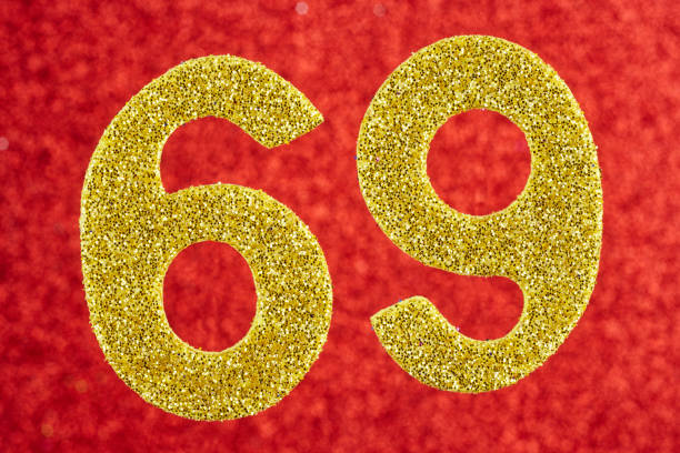 istock Number sixty-nine yellow color over a red background. Anniversary. 691419708