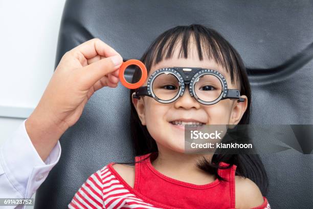Asian Little Chinese Girl Doing Eyes Examination Stock Photo - Download Image Now - Child, Eyeglasses, Asian and Indian Ethnicities