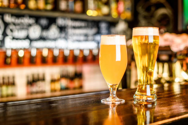 istock A two Glass of light beer on a pub with bokeh background 691438398