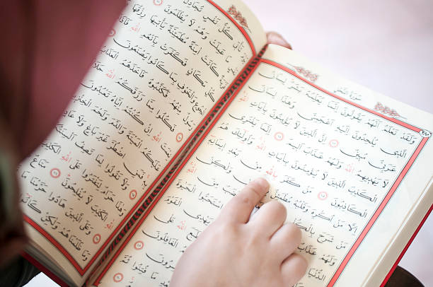 istock Young woman reading the Holy Qur'an 691438654