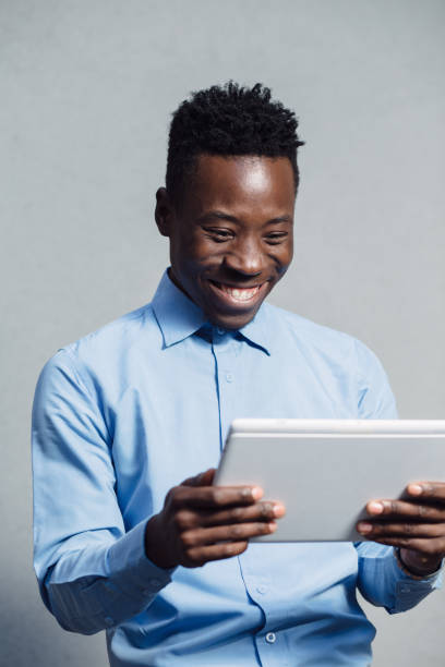 istock African american man in blue shirt using tablet PC 691441836