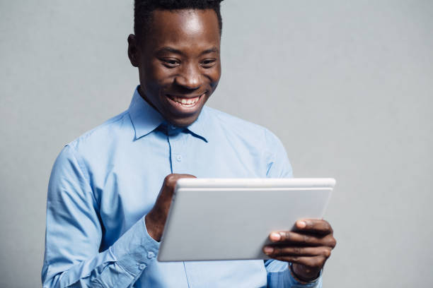 istock African american man in blue shirt using tablet PC 691441864