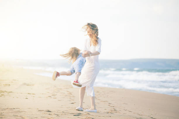 istock Mother and son having fun on the beach 691445530