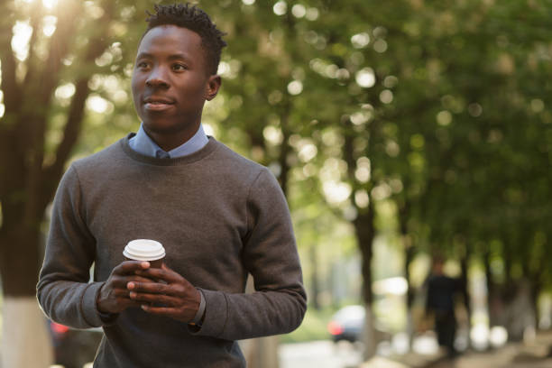 istock African american man drinking tea in sunny evening city 691447628
