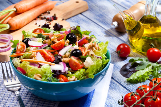 istock Fresh salad plate on blue picnic table 691448364
