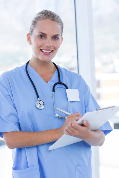 istock Happy doctor writing on clipboard 691449474