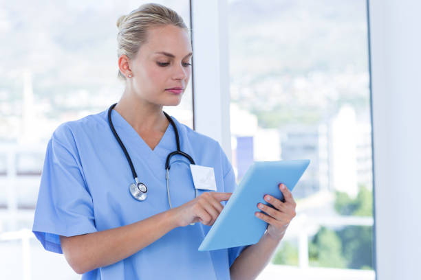 istock Serious doctor looking at clipboard 691449508
