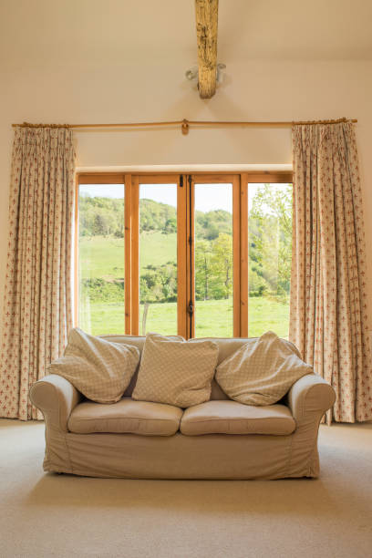istock Comfortable Couch in Front of Patio Doors 691449596
