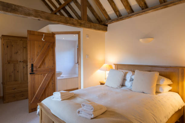 istock Holiday Cottage Bedroom Interior with Bathroom Viewed from Corner 691449662