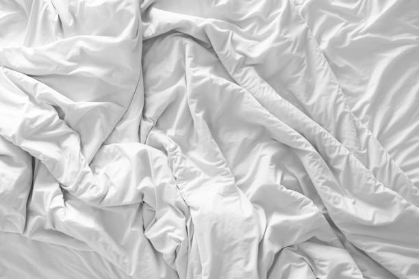 istock Top view of bedding blanket or white fabric wrinkle texture background 691453024
