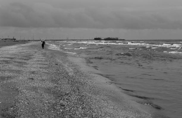 istock Lonely figure in the autumn on the beach. 691455438