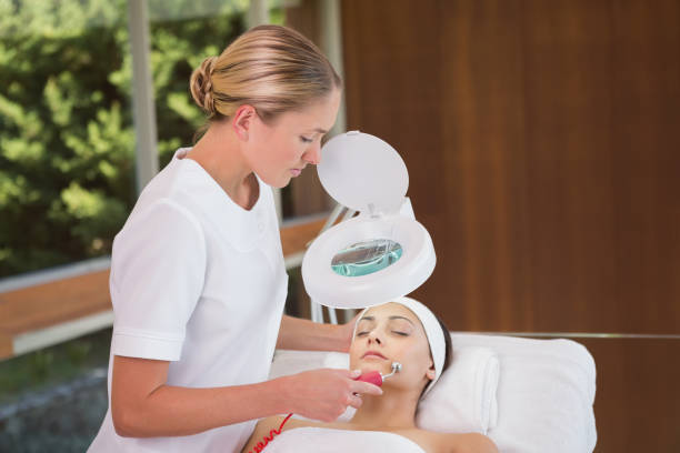 istock Peaceful brunette getting micro dermabrasion from beauty therapist 691457148